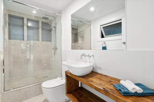 a bathroom with a sink and a toilet and a shower at Montville Retreat offgrid luxury in Montville