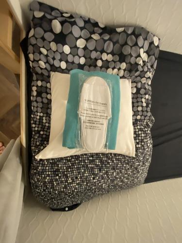 a black and white pillow sitting on a bed at 赤坂ホステル in Tokyo
