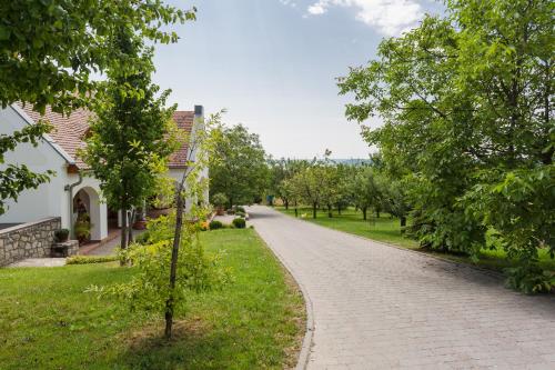 a cobblestone road in front of a house at Figula Vendégház in Balatonfüred