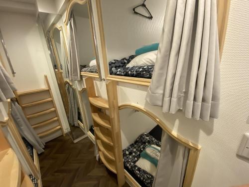 a room with three bunk beds in a room at 赤坂ホステル in Tokyo