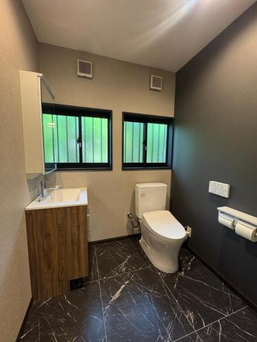 a bathroom with a toilet and a sink at 森のテラス in Karuizawa