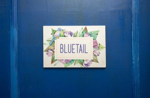 a blue door with a sign that reads blueall at Monratino The snow roost- 10 mins walking distance from mall road- Attached balcony with Kanchenjunga Mountain View-Kitchen available in Darjeeling