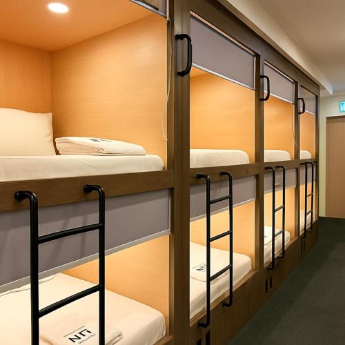 a row of bunk beds in a dorm room at Wink at Perak Road in Singapore