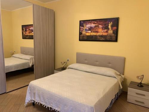 a bedroom with two beds and a large mirror at Villa panoramica Le Cerquiglie in Ascrea