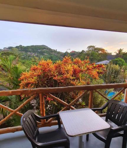 two chairs and a table on a balcony at Vaea Hotel Samoa in Apia