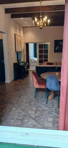a living room with a table and chairs and a bedroom at Gouda city center apartment with private garden and 2 bicycles in Gouda