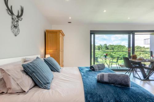 a bedroom with a large white bed with a blue blanket at 1 Bed in Buxted oc-t32799 in Buxted