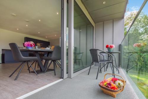 a patio with chairs and a table with a basket of fruit at 1 Bed in Buxted oc-t32799 in Buxted