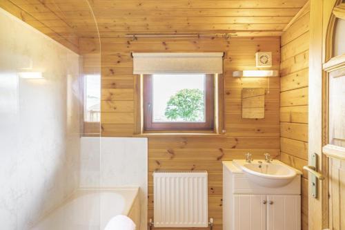 a bathroom with a sink and a toilet and a tub at 2 Bed in Llandinam oc-t32993 in Llandinam