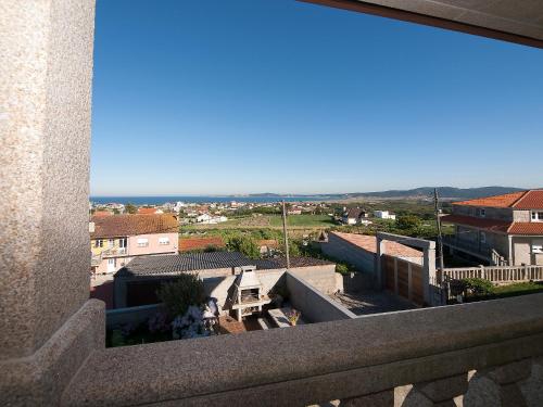 a view of a city from a balcony at Pensión Residencia A Cruzán in Noalla