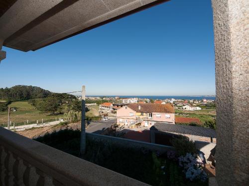 a balcony with a view of a city at Pensión Residencia A Cruzán in Noalla