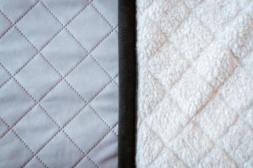a close up of a quilt on a bed at Dom Wypoczynkowy Elżbieta in Poronin
