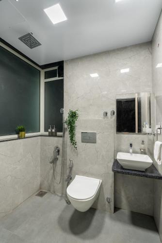 a bathroom with a toilet and a sink at Villa Azure Bliss by Riviera Hospitality in Shāhāpur