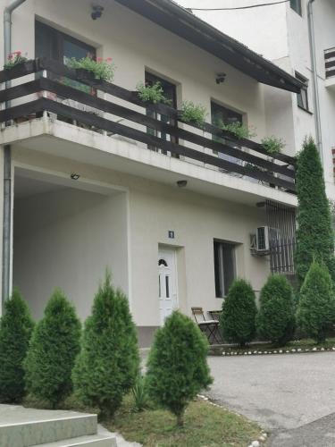 a building with a balcony with plants on it at Novi Apartman 19 in Foča