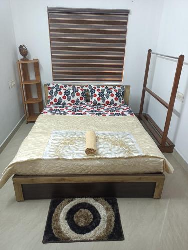 a bed with a wooden headboard in a room at River Soul Villa, Vagamon in Kattappana