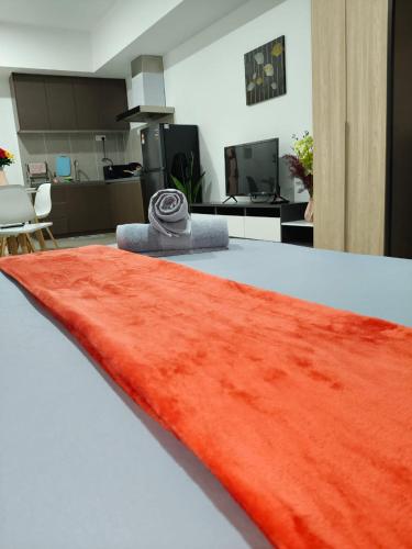 a red rug on top of a table with an office at Alinea suites DSM near by shah alam in Shah Alam