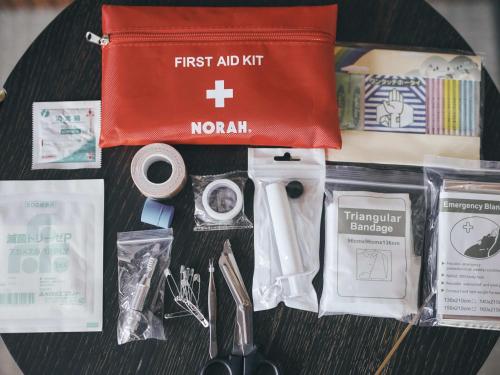 a table with a first aid kit and other items at illi Rom Hamamatsucho in Tokyo