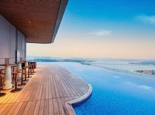 a swimming pool on a building with a view of the ocean at Alacarte Hạ Long Bích Ngọc in Ha Long