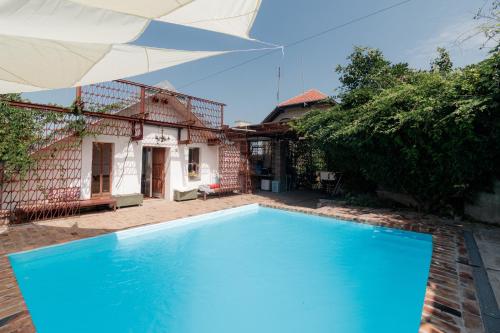 a large blue swimming pool in front of a house at Train_house_ns in Petrovaradin