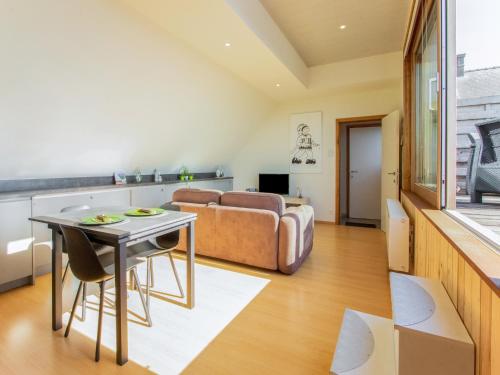 a living room with a couch and a table at Apartment in Watou near French Border in Poperinge