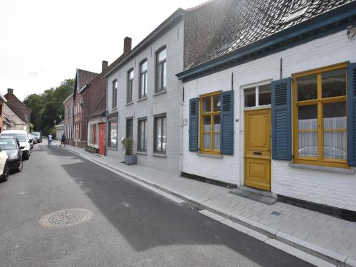a street with buildings with blue and yellow doors at Apartment in Watou near French Border in Poperinge