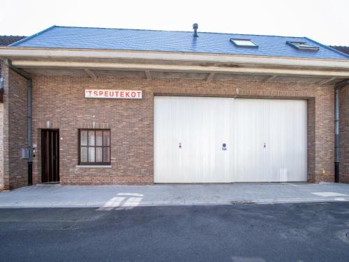 two white garage doors on a brick building at Apartment in Watou near French Border in Poperinge