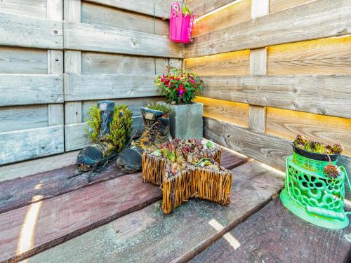 a wooden fence with a table with plants in it at Apartment in Watou near French Border in Poperinge