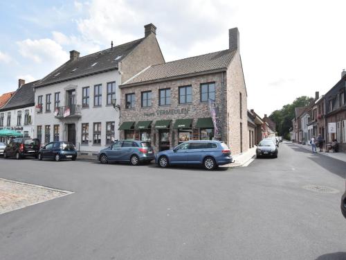 a street with cars parked in front of a building at Apartment in Watou near French Border in Poperinge