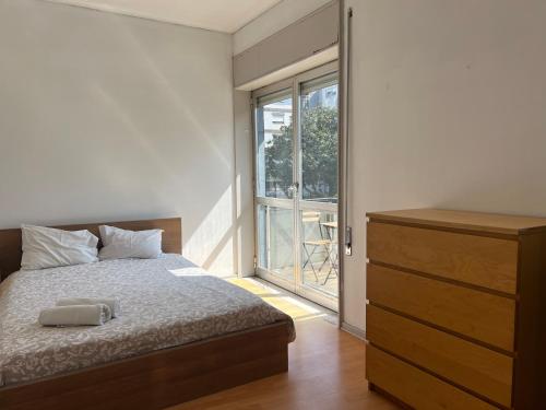 a bedroom with a bed with a dresser and a window at Smile4Porto Guest House in Porto