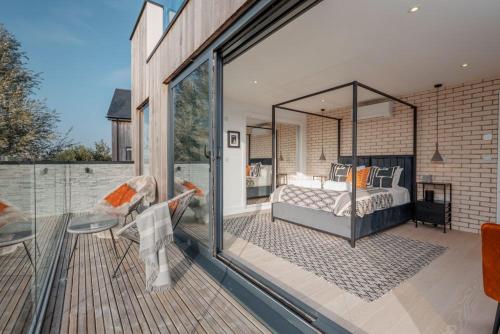 a bedroom with a bed on a balcony at The Lookout in Warmwell