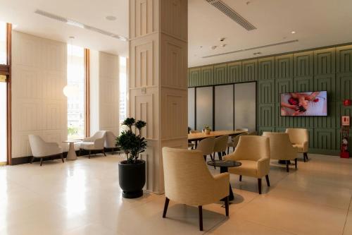 a restaurant with chairs and tables and a column at Sheraton Lima Historic Center in Lima