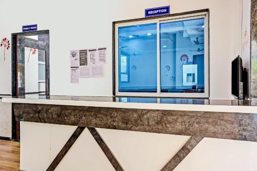 a counter in a museum with a window at Hotel O Maurya in Pune