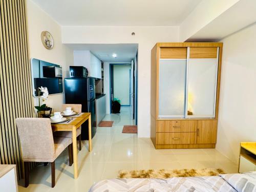 a living room with a dining table and a kitchen at J Tower Residences in Mandaue City