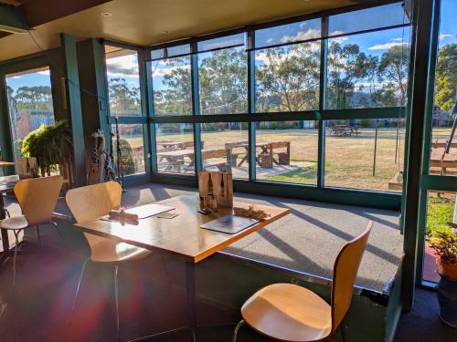 an office with a table and chairs and windows at Tandara Motor Inn in Triabunna