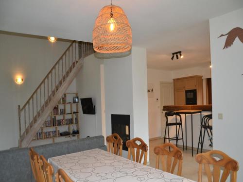 a dining room and kitchen with a table and chairs at Apartment in Antwerp near Verbeke Museum in Puivelde
