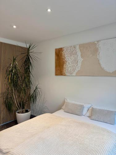 a bedroom with a bed and a painting on the wall at Helle Lichtdurchflutete Wohnung in Karsau
