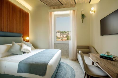a hotel room with a bed and a desk and a window at Rome for Two in Rome