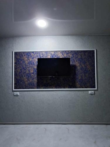 a wall with a tv on top of a wall at Ande Tower Apartment on Zgvispiris Street #6, Batumi in Minda