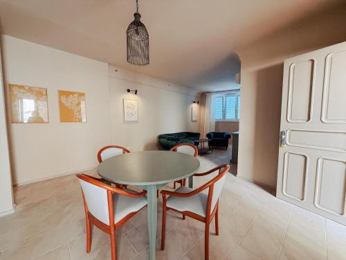 a dining room with a table and chairs at PalazzoRusso Ortigia Suite & Apartments in Siracusa