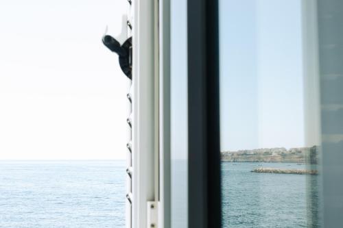 a window view of the ocean from a cruise ship at PalazzoRusso Ortigia Suite & Apartments in Siracusa