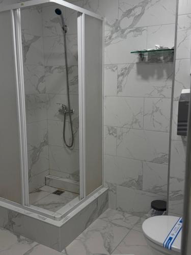 a bathroom with a shower and a toilet at In hotel in Kamianets-Podilskyi