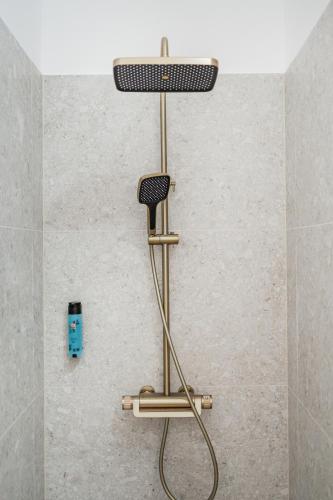a shower seat in a bathroom with a shower at HOME1 - Augarten City Stay Boutique Hostel in Vienna