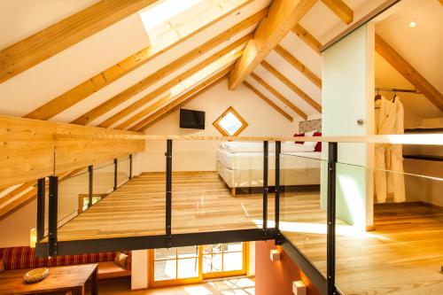 een loft met een trap en een slaapkamer bij Dorfhaus Chalets in Oberstaufen