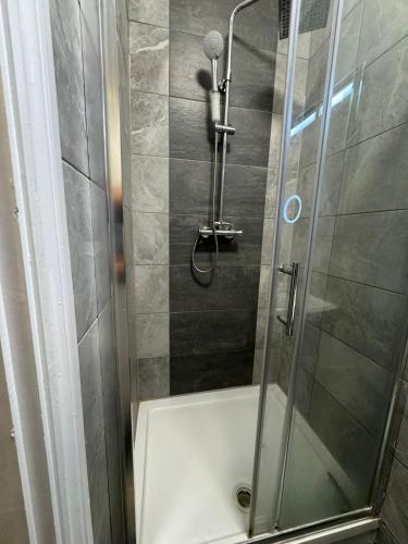 a shower with a glass door in a bathroom at Golders Park Hotel in London