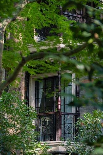 a house with a window and a iron gate at A detached, old Shanghai villa on Huaihai Middle Road in Shanghai