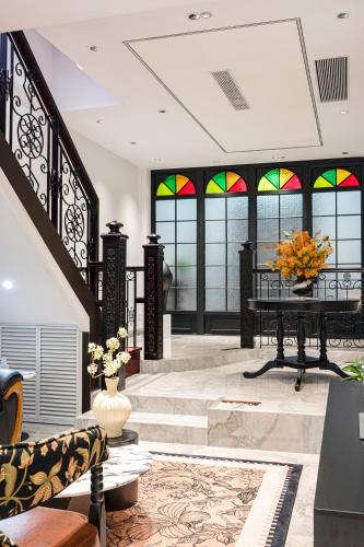 a living room with a table and stained glass windows at A detached, old Shanghai villa on Huaihai Middle Road in Shanghai