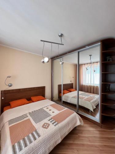 a bedroom with a bed and a large mirror at Сдам 3х комнатную квартиру у моря! in Chornomorsk