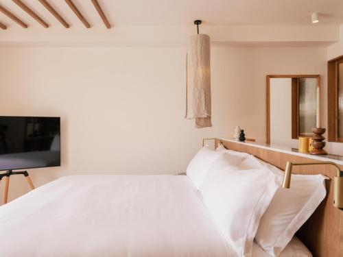 a bedroom with a white bed and a television at ME Marbella by Meliá in Marbella