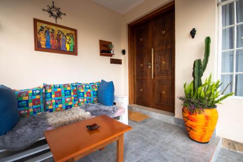 a living room with a couch and a table and a cactus at Mytime in Nanyuki
