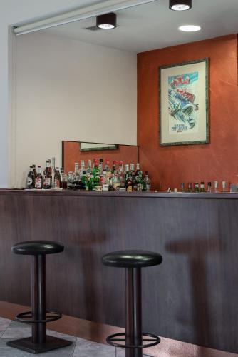 a bar with two black stools at a counter at Park Hotel Ripaverde in Borgo San Lorenzo